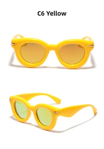 Detailed close-up of retro cat-eye sunglasses in bright yellow with gold rivet accents