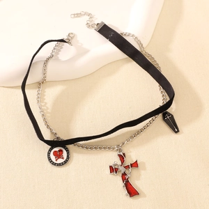 Gothic choker detail featuring red cross, skull heart, and coffin charms on black velvet