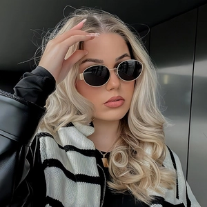 Classic oval metal frame sunglasses with dark lenses on female model for vintage style