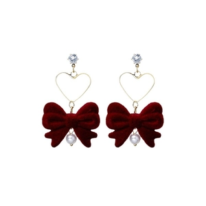 Red velvet bow earrings with gold heart frame and white pearl drop on white background