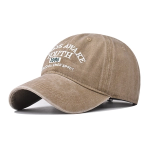 Macro view of vintage khaki washed cotton baseball cap featuring YOUTH embroidery