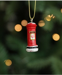 Macro shot of a red resin mailbox Christmas tree ornament with a heart and gold string