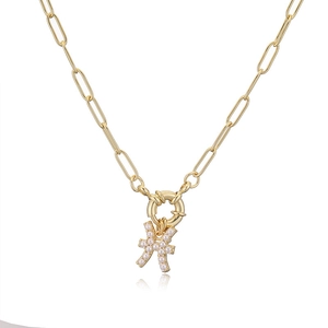 Detail of elegant gold copper necklace with white pearl and Pisces zodiac pendant