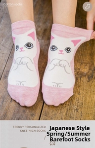 Close-up of pink and white cotton low-cut socks with a cute cartoon cat design