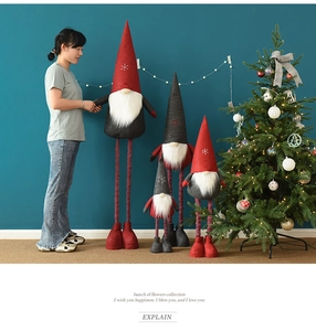 Close-up of telescopic Christmas gnomes with snowflake embroidery and striped knitted legs