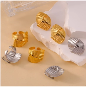 Detailed view of 18K gold and silver plated spiral textured rings and stud earrings set