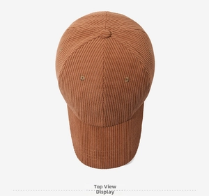 Vertical top view of a brown corduroy baseball cap showing six-panel crown and texture