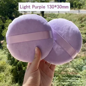 Macro shot of 130x30mm light purple velvet powder puff with ribbon handle for body setting