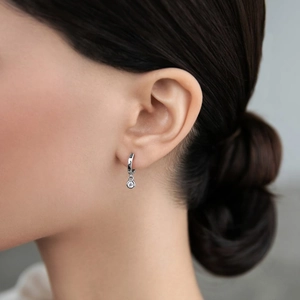 925 sterling silver hoop earrings with zircon cross pendants on a female model
