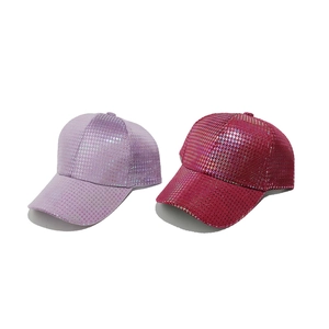 Detail of laser reflective houndstooth pattern on purple and pink baseball caps