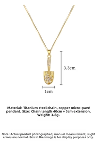 Macro detail of shovel pendant with micro-pave zircons and titanium steel chain