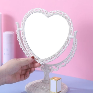 Vintage heart-shaped beige desktop makeup mirror with embossed frame on stand
