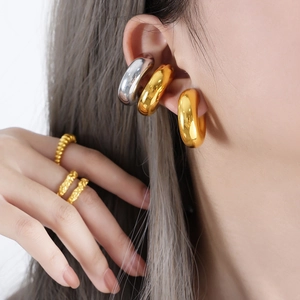 Chic minimalist thick gold and silver hoop earrings with textured stackable gold rings