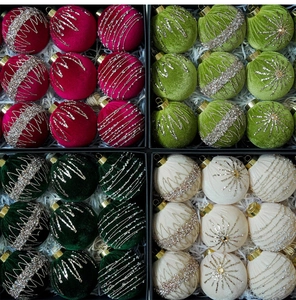Detailed view of luxury velvet Christmas ornaments in red and green with glitter patterns
