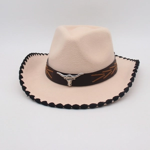 Detailed close-up of beige cowboy hat with silver bull head buckle and woven brim edge