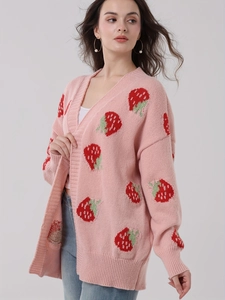 Pink knit cardigan with strawberry patterns and V-neckline shown on female model