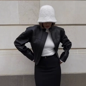 Women's trendy black short PU leather jacket paired with a white fluffy bucket hat