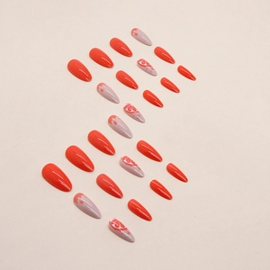 Faux ongles amande orange avec motifs d'agrumes et de fleurs au fini brillant