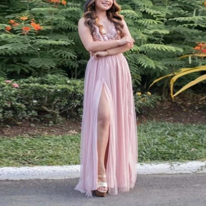 Detail of pink sequin bodice and high slit mesh skirt on a floor-length evening dress