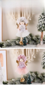 Detailed view of plush Christmas angel dolls with lace collars and golden wings