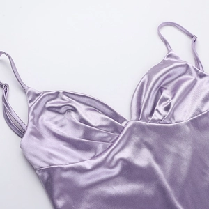 Detail of lavender satin dress featuring adjustable spaghetti straps and pleated neckline