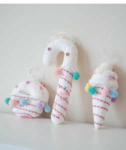 Detail of colorful candy cane and donut ornaments with plush balls for Christmas decor