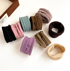 Close-up of nine colorful seamless wide elastic hair ties in Morandi tones on white background