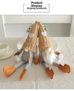 Close-up of Nordic gnome plush dolls with knitted hats on a cozy checkered table surface