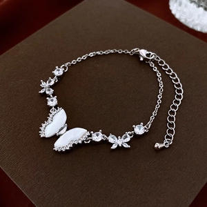 Detail of silver butterfly bracelet with zircon and shell inlay on luxury gift box