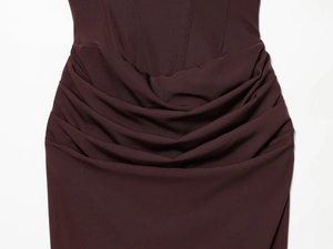 Close-up of elegant pleated waist detail on a deep burgundy bodycon midi dress