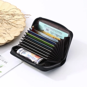 Top view of open leather accordion card wallet showing multiple slots and large capacity