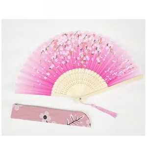 Detail of pink cherry blossom folding fan with bamboo ribs and matching embroidered pouch