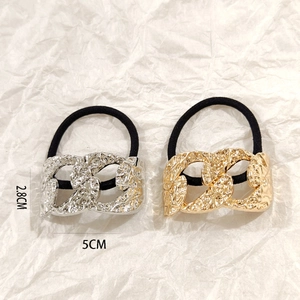 Detail of gold and silver irregular chain metal hair ties with dimensions 5CM by 2.8CM