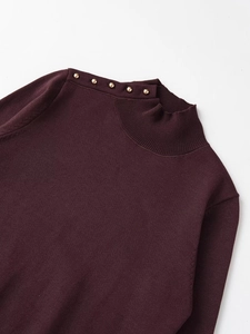 Close-up of knit sweater neck with decorative gold buttons and soft purple fabric