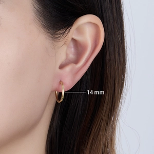 Side view of 14mm gold-plated sterling silver hoop earring worn by a model