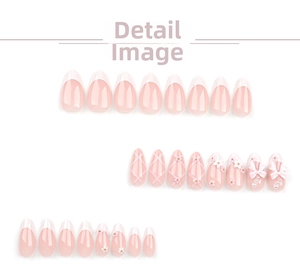 Detail of pink almond fake nails with 3D bows, white French tips and pearl flowers
