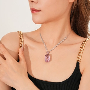 Detail showing a rectangle pink zircon pendant on a silver chain worn by a female model