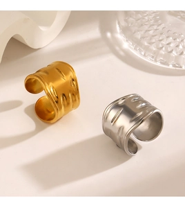 Detail of wide open rings with hammered texture in gold and silver finishes