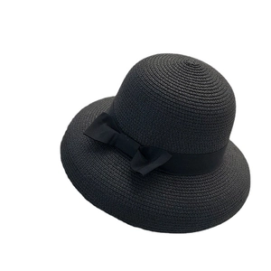 Women's black straw sun hat with elegant side bow on a clean white background