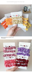 Detail of satin scrunchies in vibrant colors displayed on a Sweet Girl card