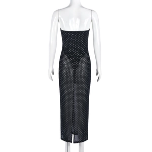 Détail de la robe en maille noire transparente avec strass et fente au dos