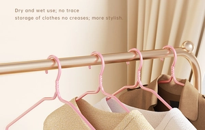 Detail of pink non-slip hanger showing shoulder texture for dry and wet no-trace storage