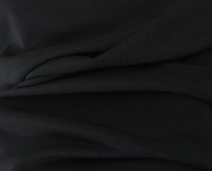 Detailed macro view of black ribbed fabric texture with elegant vertical knit pattern