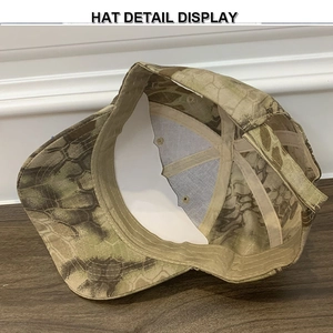 Macro view of camo tactical cap showing reinforced stitching and metal air vents