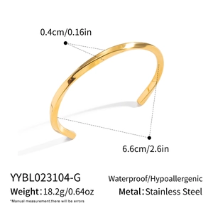 Macro shot of polished 18K gold plated stainless steel twisted open cuff bracelet details