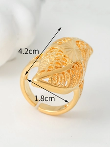 Detailed macro view of 4.2cm large hollow gold ring with intricate floral patterns