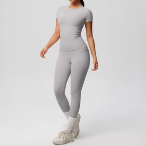 Close-up of grey yoga set with breathable fabric and side pockets on high waist leggings