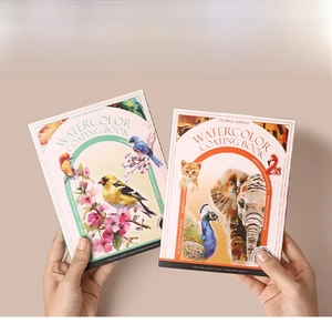 Close-up of portable watercolor painting book set with built-in pigments and brush
