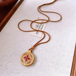 Vintage gold circular镂空 pendant necklace with zircon and purple gemstones on woven cord
