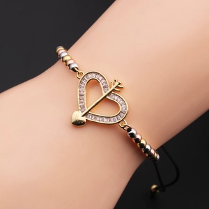 Detail of Cupid heart charm bracelet with zircon inlays on a black adjustable cord
